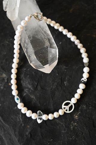 white pearl necklace with charms